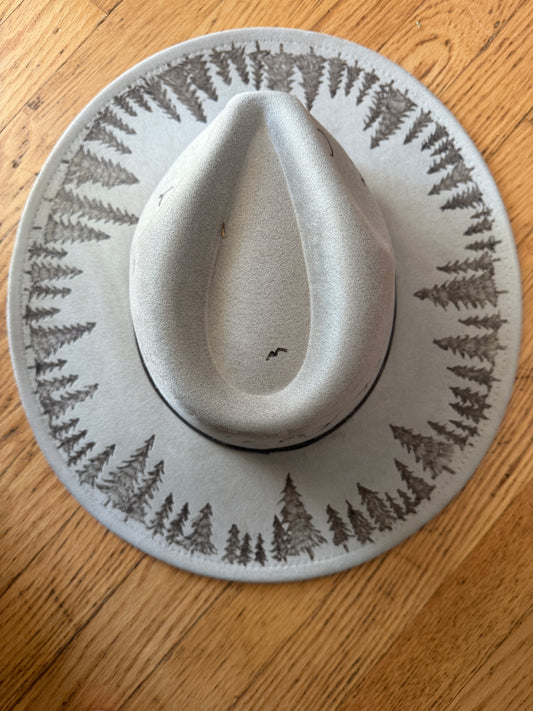 Mountain scene with trees on brim