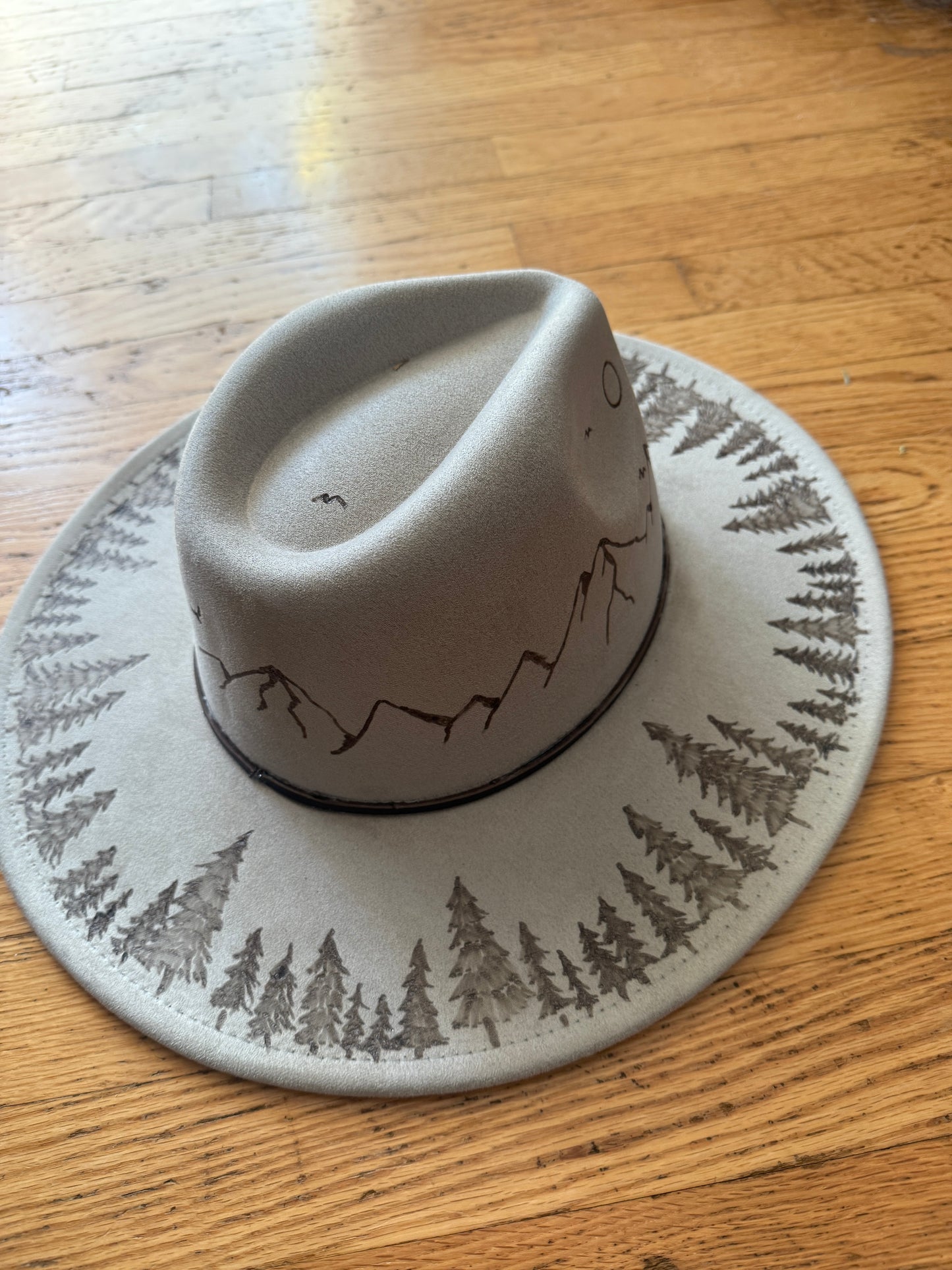 Mountain scene with trees on brim