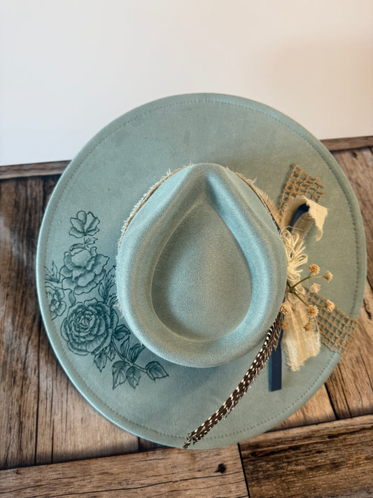 Burned flowers on blue hat with fancy band